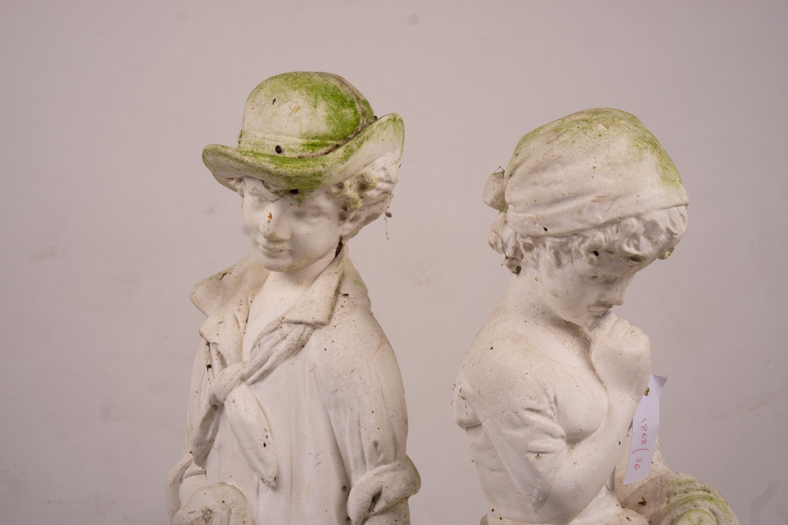 A reconstituted stone garden ornament of fruit and flower pickers, height 89cm